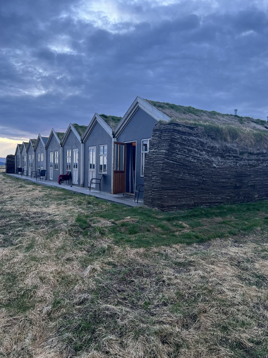 lbleamas's tweet photo. Day 9, part 2: longest day of driving had us continuing east and north through the fjords and the mountain (relatively new tunnel cut 50 km off the normal route). Then a stop at historic turf houses (red) from 1770, before our modern turf hotel (blue). @Trinity_U #goTUiceland https://t.co/Iv1WskxXUf