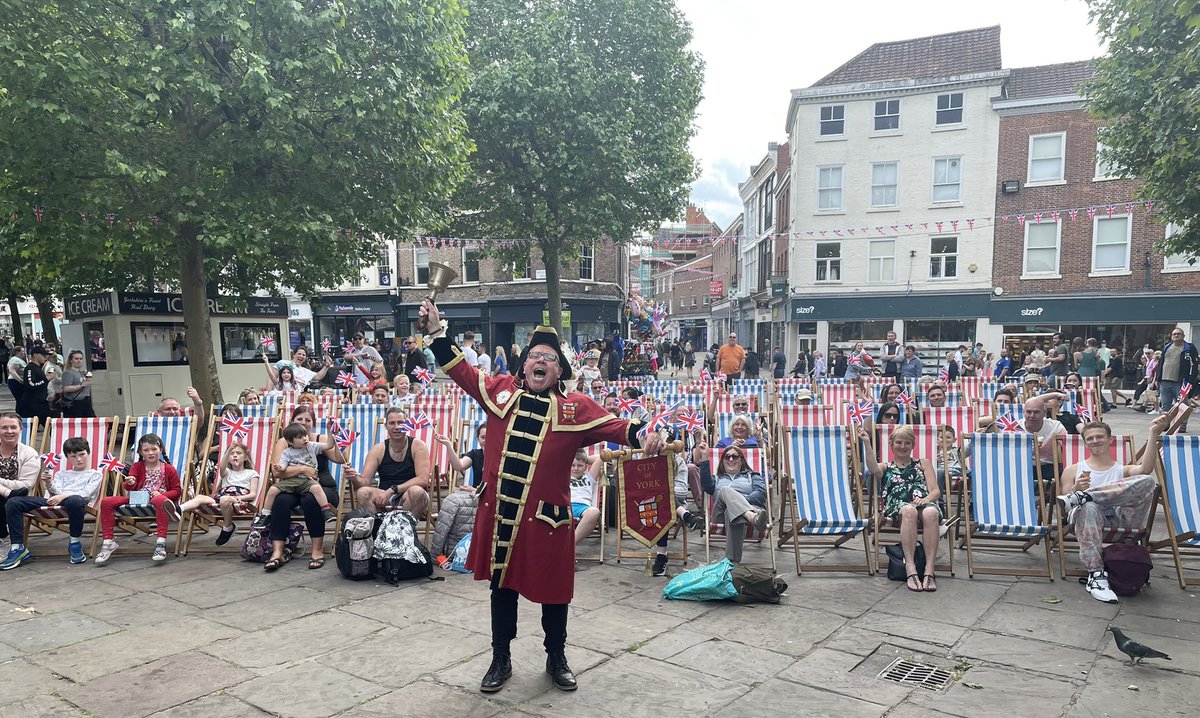 BenYorkMix's tweet photo. Flag waving in St Sampson’s Square @CityofYork on @theyorkbid deckchairs #Oyez #PlatinumJubilee https://t.co/8K6FGFtVYE