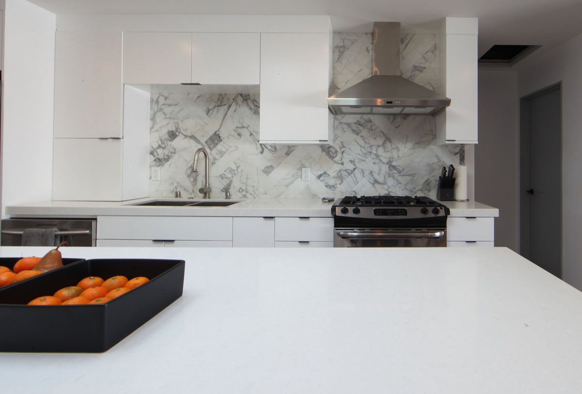 Open kitchen design with a large eat-in island serves well for everyday dining and entertaining. Folding glass doors connect the interior to the outdoor area creating more living area #ThrowbackThursday #interiordesign #redondobeachhomes #residentialdesign #architecture