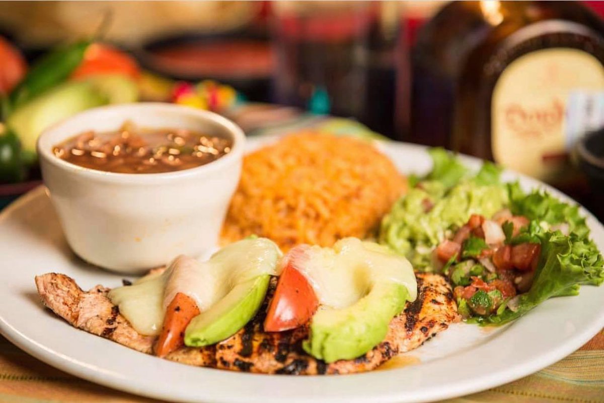 Something from the grill! Our Pollo Cozumel - Grilled marinated breast of chicken covered with avocado slices and sauteed tomato with melted Monterrey cheese. #HenrysPuffyTacos