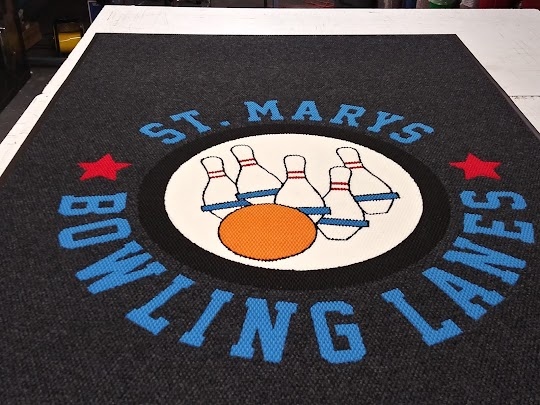Sun's out, time to do some bowling at St. Mary's! This inlaid logo mat aggressively removes dirt &amp; wicks water away with every step to ensure a safe &amp; clean floor inside your building. The random tufted pattern &amp; dark coloring make small patches of dirt virtually invisible
