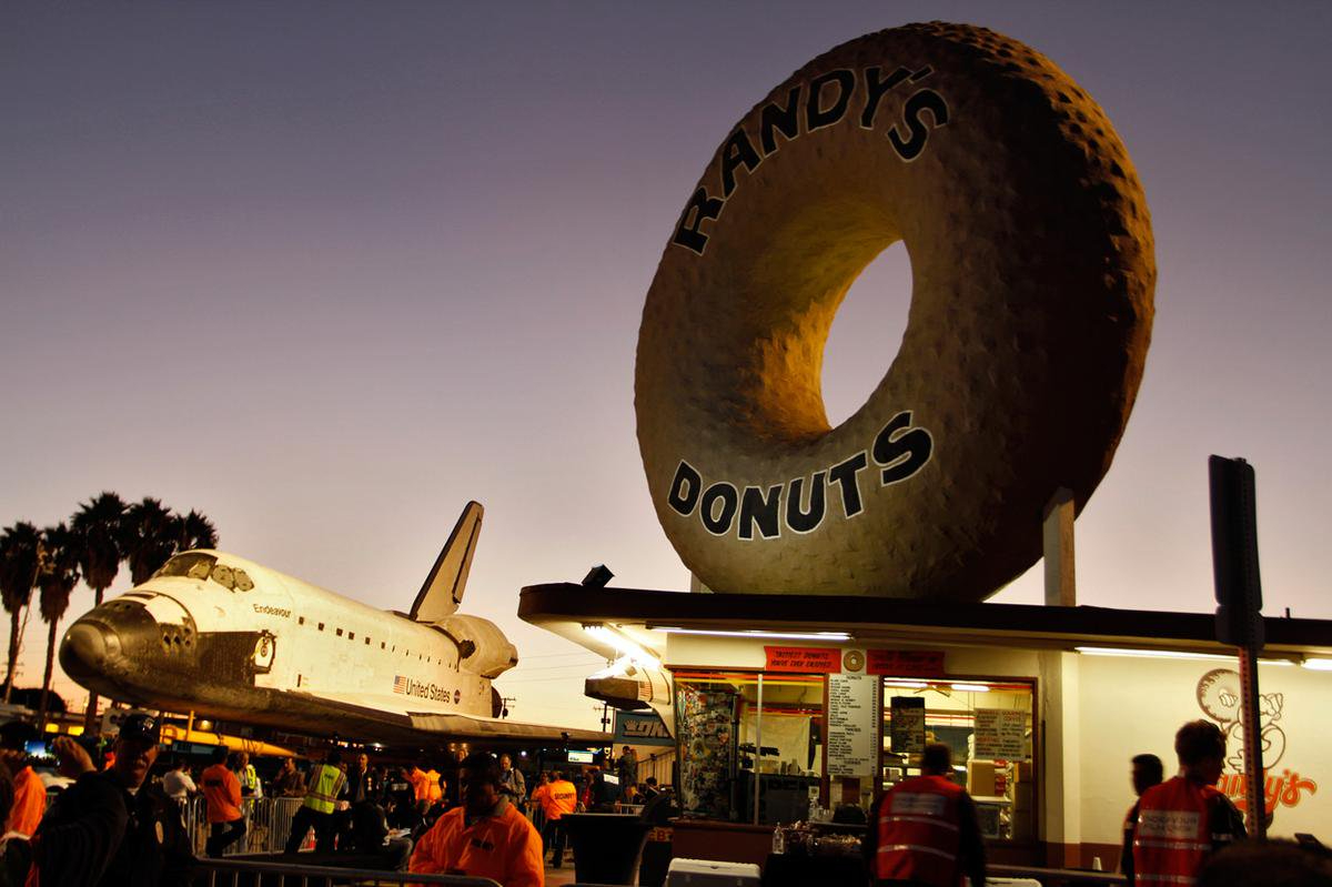 The Space Shuttle Endeavour passes by Randy’s Donuts in Los Angeles, 2012. #NationalDonutDay