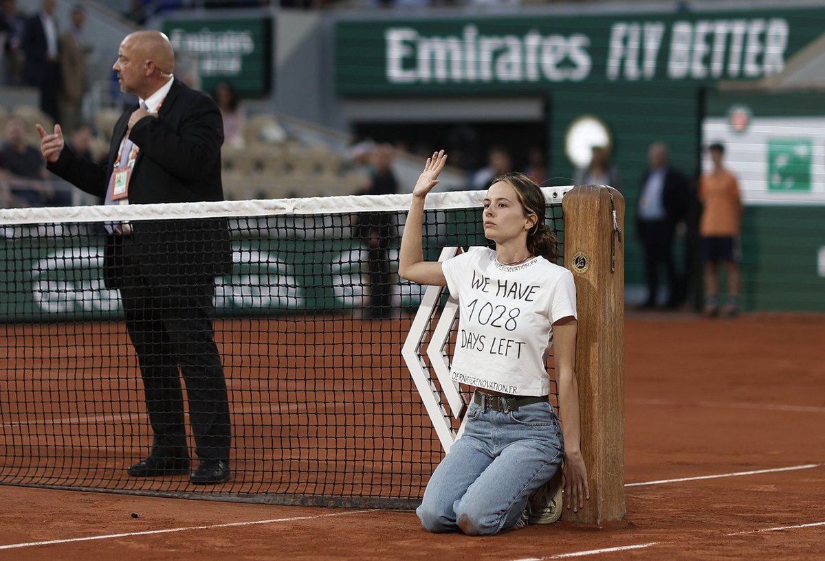 CerfiaFR's tweet photo. 🎾 FLASH | Une femme s’est accrochée au filet lors du match entre Casper #Ruud et Marin #Cilic. Militante du collectif #DernièreRénovation, elle portait un t-shirt "il nous reste 1 028 jours", afin d’alerter sur l’urgence climatique, a-t-elle déclaré ensuite.

(CF) #RolandGarros https://t.co/aetTgLsDro
