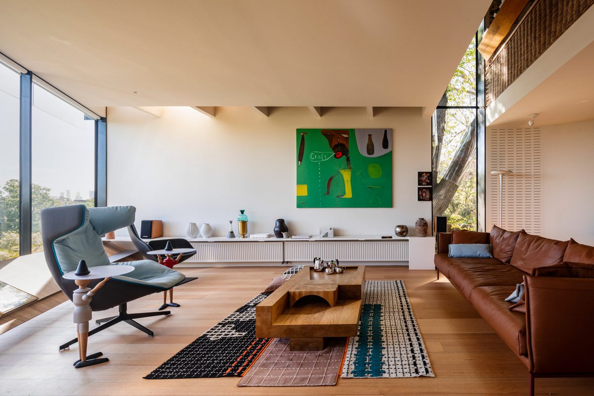 dezeen's tweet photo. Ten modernist living rooms that celebrate minimalist open-plan interiors: https://t.co/lYct8GQLOG https://t.co/pfAuFJ4db0