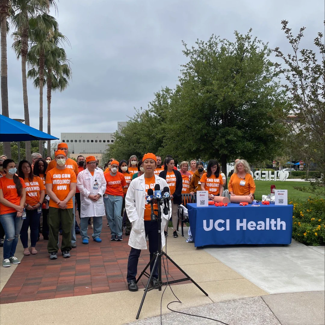UCI Health trauma team wearing orange and gathering to commemorate Gun Violence Awareness Day.