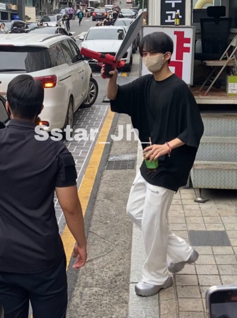 thinkabtsh's tweet image. dokyeom walking out with a puppy in either hand and jeonghan having Weaponry and a Gay Little Iced Coffee