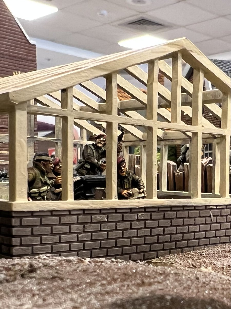 Dozibugger's tweet photo. In the true style of a Brit abroad, Corporal Titchmarsh trashes Mrs Van de Bergs greenhouse display,  setting up the vickers and then shredding the bay window of the house across the road. #chainofcommand #OML8.2. In the background, private Binns has raided the wine cellar. https://t.co/MMrDKzJdL1