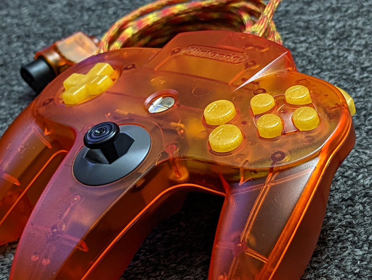 gamrjerome's tweet photo. This isn't this controllers final form, just trying the @RockerGameMod 24k buttons on this setup. Later they will go into another project. Awesome buttons though. Other mods on this controller, #steelsticks64 B bowl, @kitschbent stick/gears and 10ft Paracord done by myself. https://t.co/CWFUTj6baz