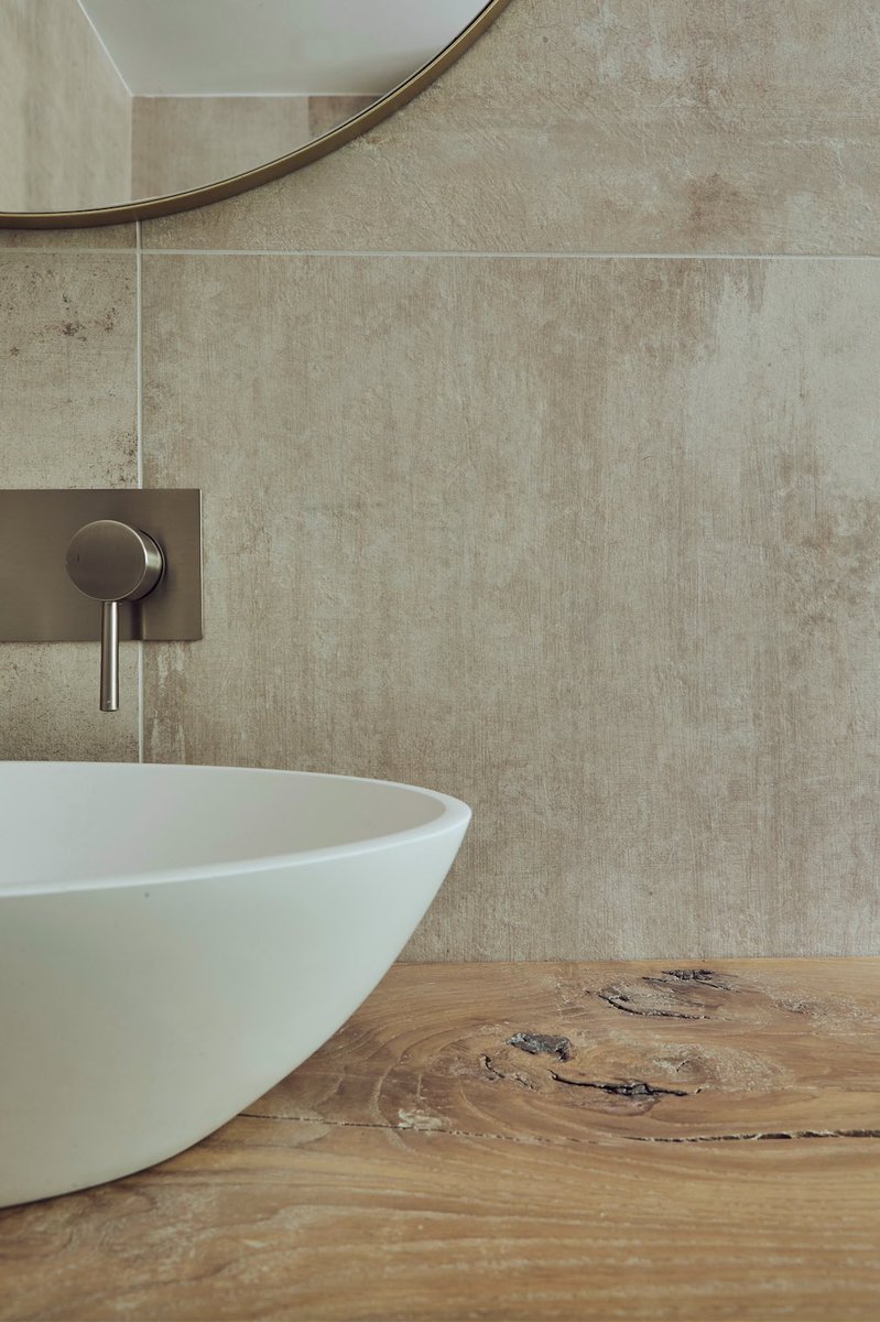 A perfect harmony between the natural and manmade materials…

These beautifully crafted floating shelves with waney edges carry a simple oval basin effortlessly. Complemented nicely by an elegant large format porcelain tile and sophisticated brushed nickel brassware.