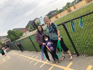 Supporting #OurLondonFamily today with green and purple ribbons on our Kindergarten fence. <a href="/LDCSB/">London District Catholic School Board</a> Beautiful community garden in the background at Maple Grove Park.