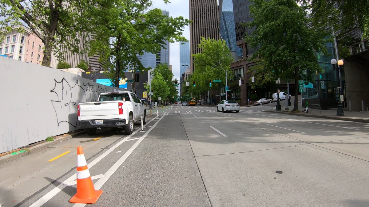 bobco85's tweet image. I passed through there this morning, too, and had to detour into the traffic lane (they didn’t say anything to me); here are screenshots from my GoPro

I agree, SDOT easily could have blocked a traffic lane to allow people using bicycles/scooters/etc to safely pass #SEAbikes