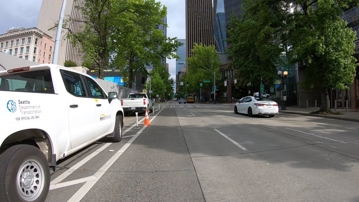 bobco85's tweet image. I passed through there this morning, too, and had to detour into the traffic lane (they didn’t say anything to me); here are screenshots from my GoPro

I agree, SDOT easily could have blocked a traffic lane to allow people using bicycles/scooters/etc to safely pass #SEAbikes