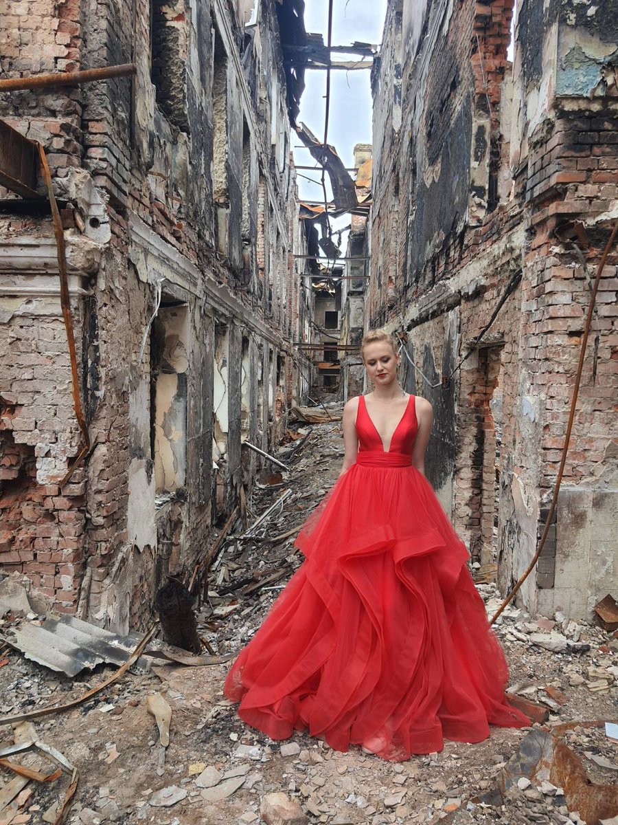 Kharkiv school graduate in her graduation dress on the rubble of her school destroyed by the Russian artillery