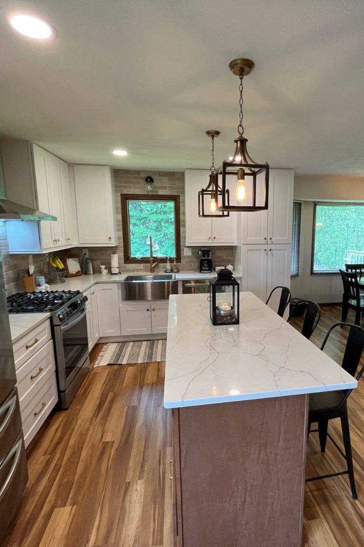 Featuring COREtec Plus 5" Plank Red River Hickory, this kitchen is sure to leave your guests impressed! The white marble countertops give you the freedom to choose any color scheme. Warm toned flooring compliments this space beautifully! dlvr.it/SRnM4B
