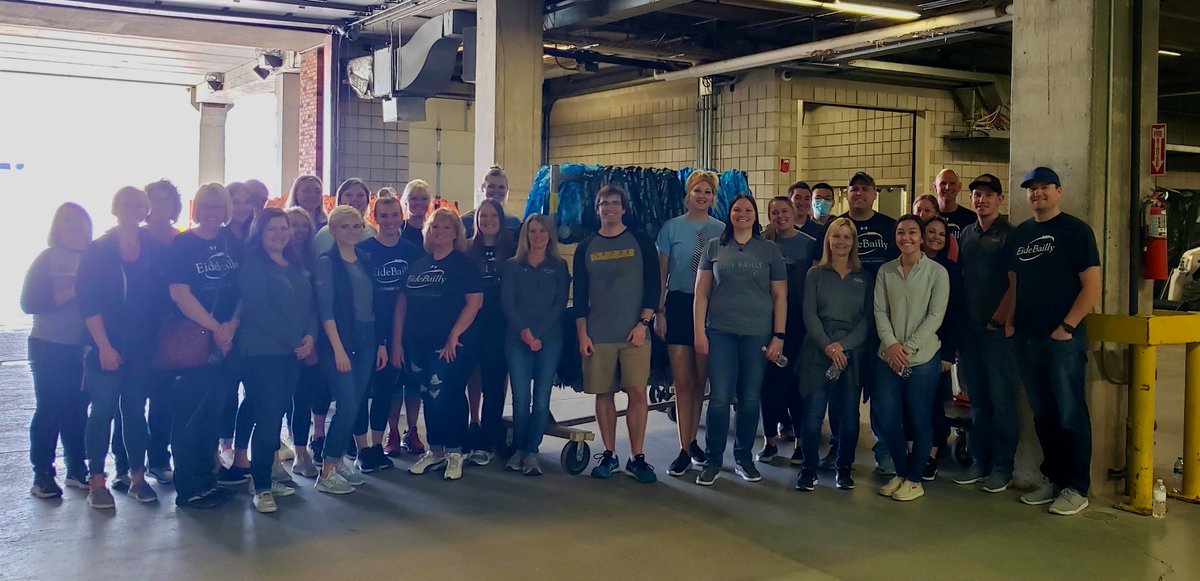 The Fargo office took the afternoon to help volunteer for the Fargo Marathon. 🏃‍♀️🏃‍♂️They helped hang signage inside the dome, set up shirts for the packet pickup, and unpacked medals for racers. Nice work team! 👏 #InsideEB