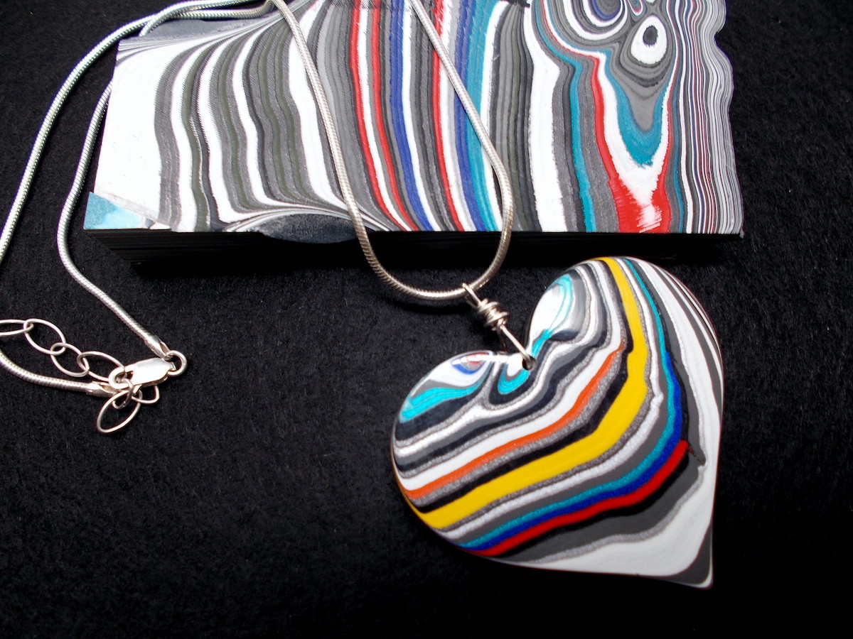 bluedotlivingmv's tweet photo. Cynthia McGrath's "Original Cyn" jewelry is created from Fordite: carved and polished pieces of the built-up residue left behind in car painting facilities. https://t.co/gK4uRyTO7r #Jewelry #Fordite #FoundArt https://t.co/m3G1xJTpSq