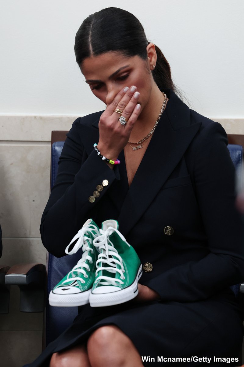 ABC's tweet image. Camila Alves McConaughey, wife of actor Matthew McConaughey, holds a pair of shoes worn by one of the victims of the school shooting in Uvalde, Texas, as her husband makes a passionate plea for gun reform at White House press briefing. abcn.ws/3mnETrZ