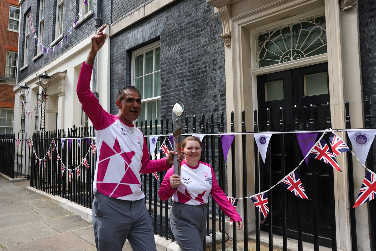 10DowningStreet's tweet photo. It’s 50 days to go until the #CommonwealthGames in Birmingham!  

This week The Queen’s Baton passed through Downing Street carried by Kash Gill – a world champion kickboxer – and Courtney Hughes, who received a Points of Light award for services to the elderly and vulnerable. https://t.co/p9buzqWiGo