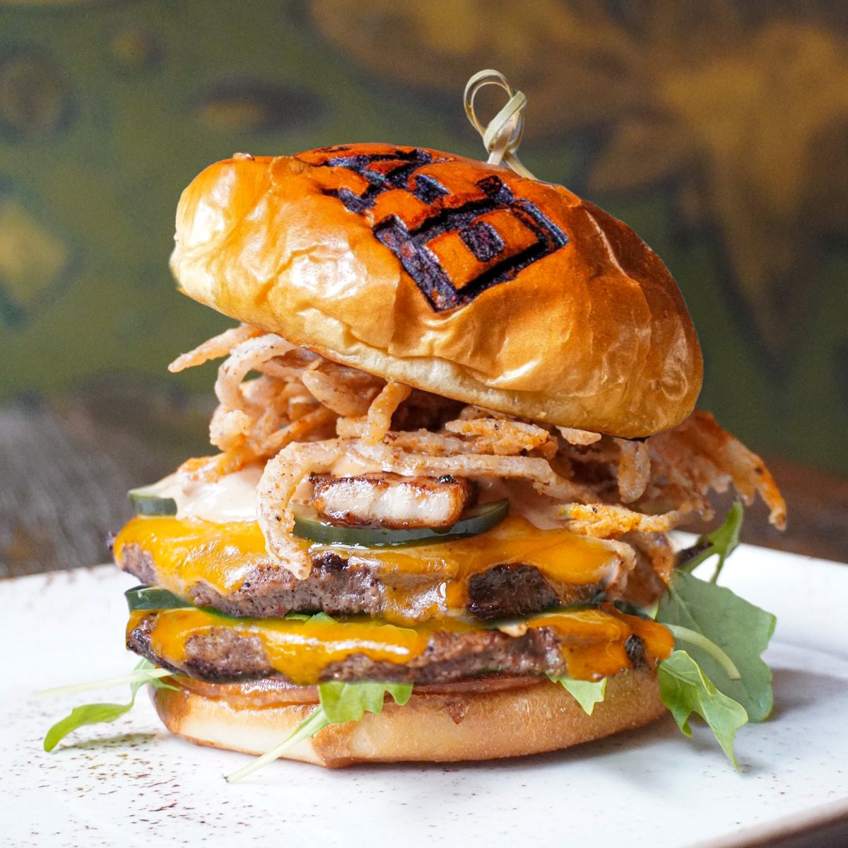 Behold the Mad Burger 🤩
[ black angus beef double patties, mad hot sauce, house pickles, baby arugula, fried onions, cheddar, crisp pork belly, brioche bun | served with house fries ]