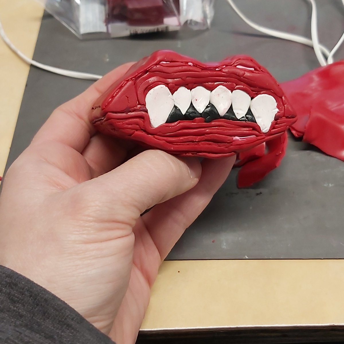 tooaquarius's tweet image. Reducing odd shaped canes is tedious but customer wanted it lip shaped. Half for the order and I am going to add a fun background for the other half. #polymerclay #waxlips #ArtistOnTwitter