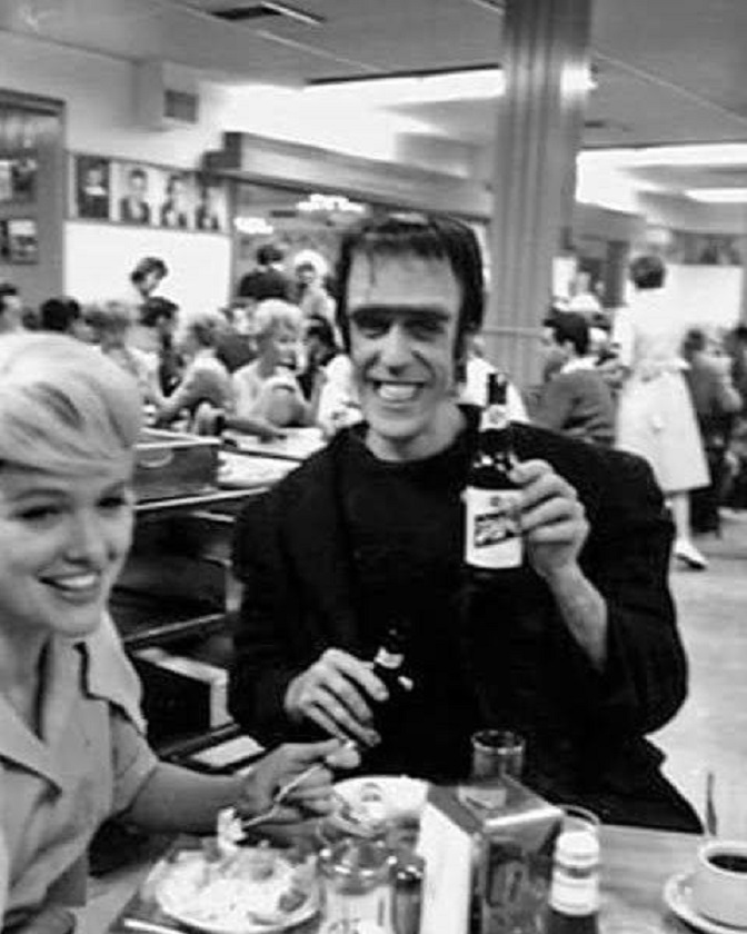 HorrorHammer1's tweet image. Fred Gwynne pounding beers on the set of The Munsters with Beverly Owen 1965