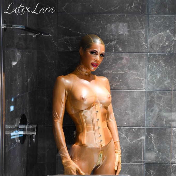 Lara again in her favorite outfit. A great color pop in this beautiful shower. #Latexcatsuit and #Latexcorset