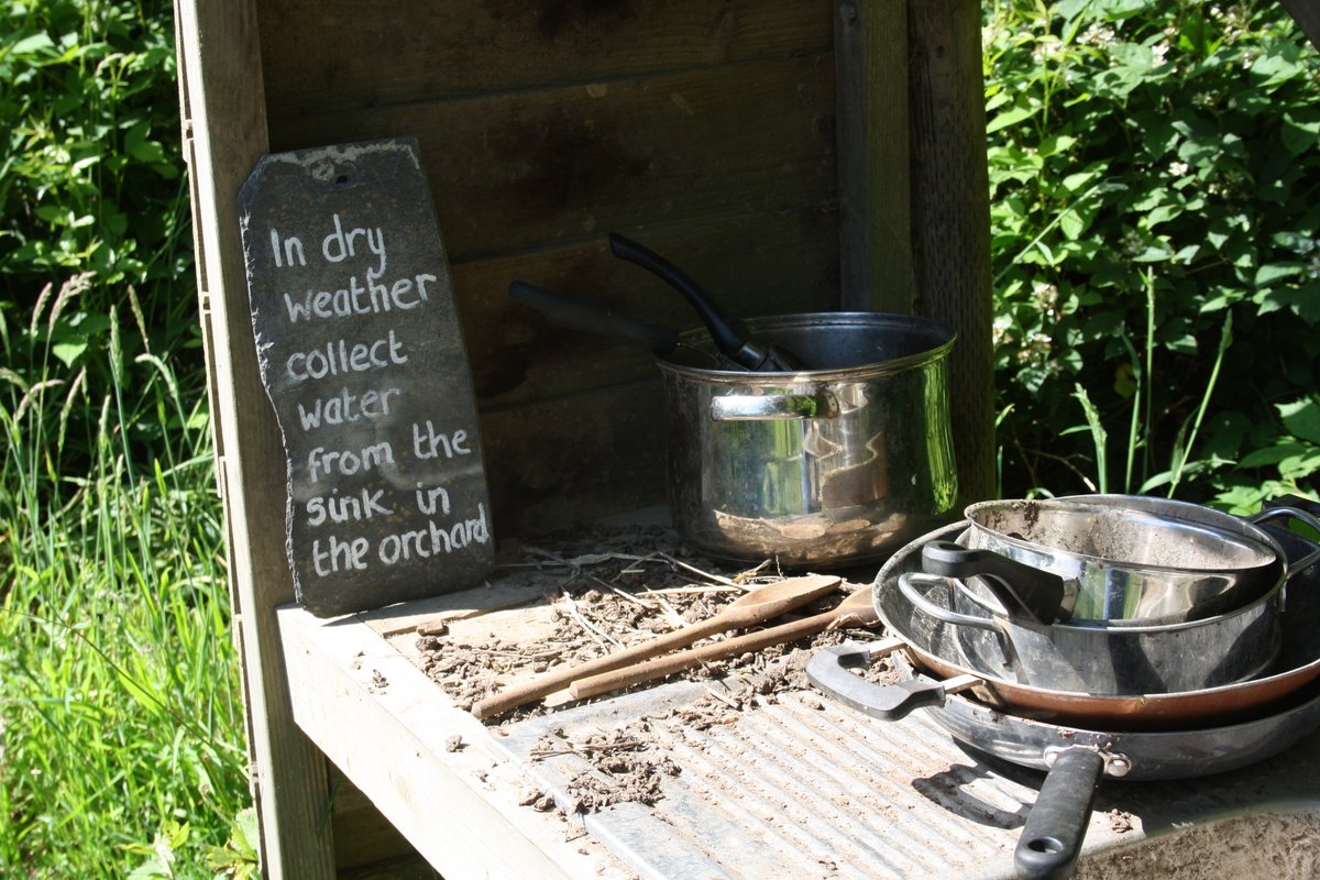 Down the winding path in Mary's #Wood, something #muddy is afoot...☀️

It's our #mudpie kitchen! Feeling a little dry? There's always the sink in the #orchard for water refills. 

#nationaltrust #cornwall #nationaltrustgardens #nationaltrusthouses #mudpiekitchen #cornwall