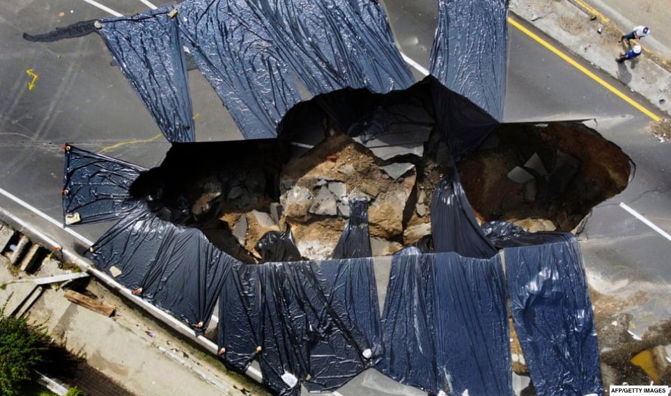 Giant hole caused by the collapse of a drain network due to heavy rains, in Villa Nueva, 10 miles south of Guatemala City.