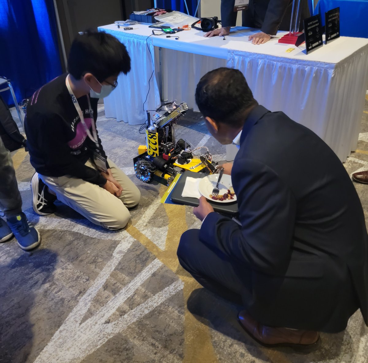 One of the coolest (of many!) photos from #ICTD22 - a young boy giving a robotics demonstration to attendees.