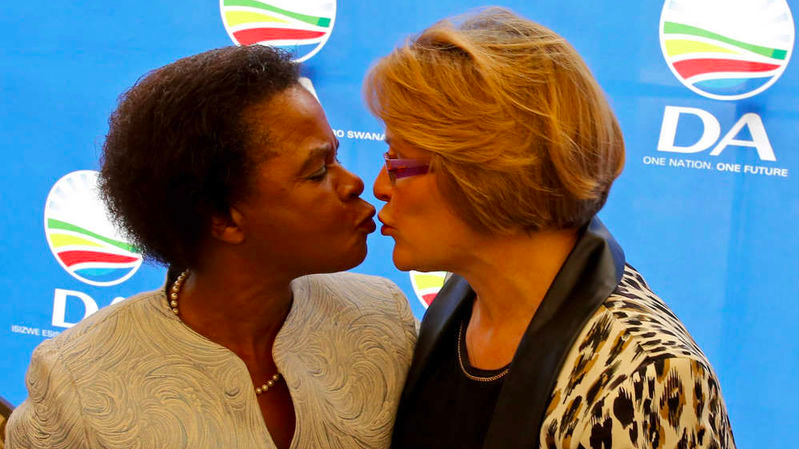 CrazySAPol's tweet photo. Mamphela Ramphele kisses Helen Zille at the merge event for their two parties https://t.co/5N6jJYDiGv