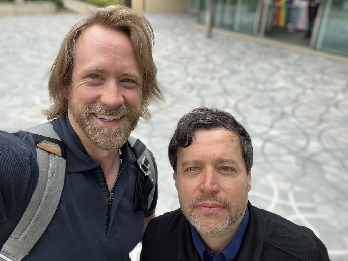 heiser's tweet photo. Behind Dr. Kahle and me is a lovely set of Penrose tiles overseen by the great man himself, just outside the Andrew Wiles Mathematics building at Oxford University. https://t.co/vhIOEtaDIW