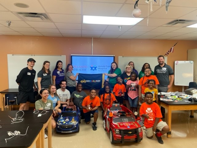 UCF_DPT's tweet photo. Orlando Health Community Benefit & @UCF_GoBabyGo came together to hold a Kids Building for Kids Workshop at Orange Center Elementary. Our students and clinicians worked side by side. Leo, the little driver in photos attached, was thrilled to receive his new wheels! #whyUCFDPT https://t.co/HdvVcNqBaj