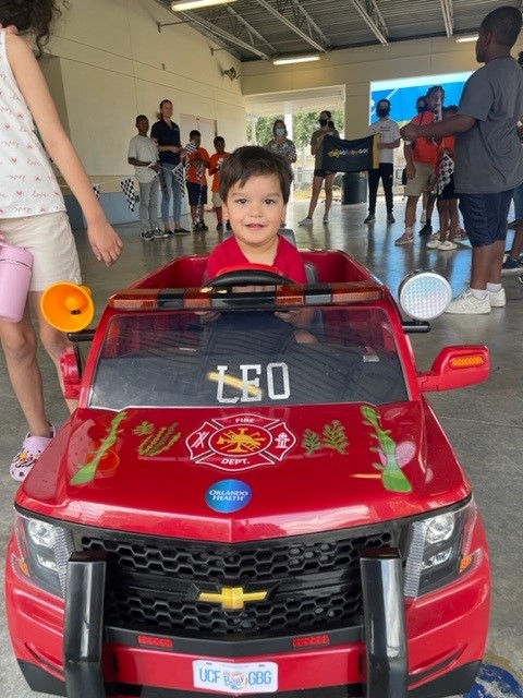 UCF_DPT's tweet photo. Orlando Health Community Benefit & @UCF_GoBabyGo came together to hold a Kids Building for Kids Workshop at Orange Center Elementary. Our students and clinicians worked side by side. Leo, the little driver in photos attached, was thrilled to receive his new wheels! #whyUCFDPT https://t.co/HdvVcNqBaj