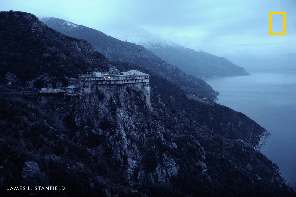 NatGeo's tweet photo. A 14th-Century monastery sits on a cliff above the Aegean Sea in Mount Athos, Greece https://t.co/JSKxpMnqNk