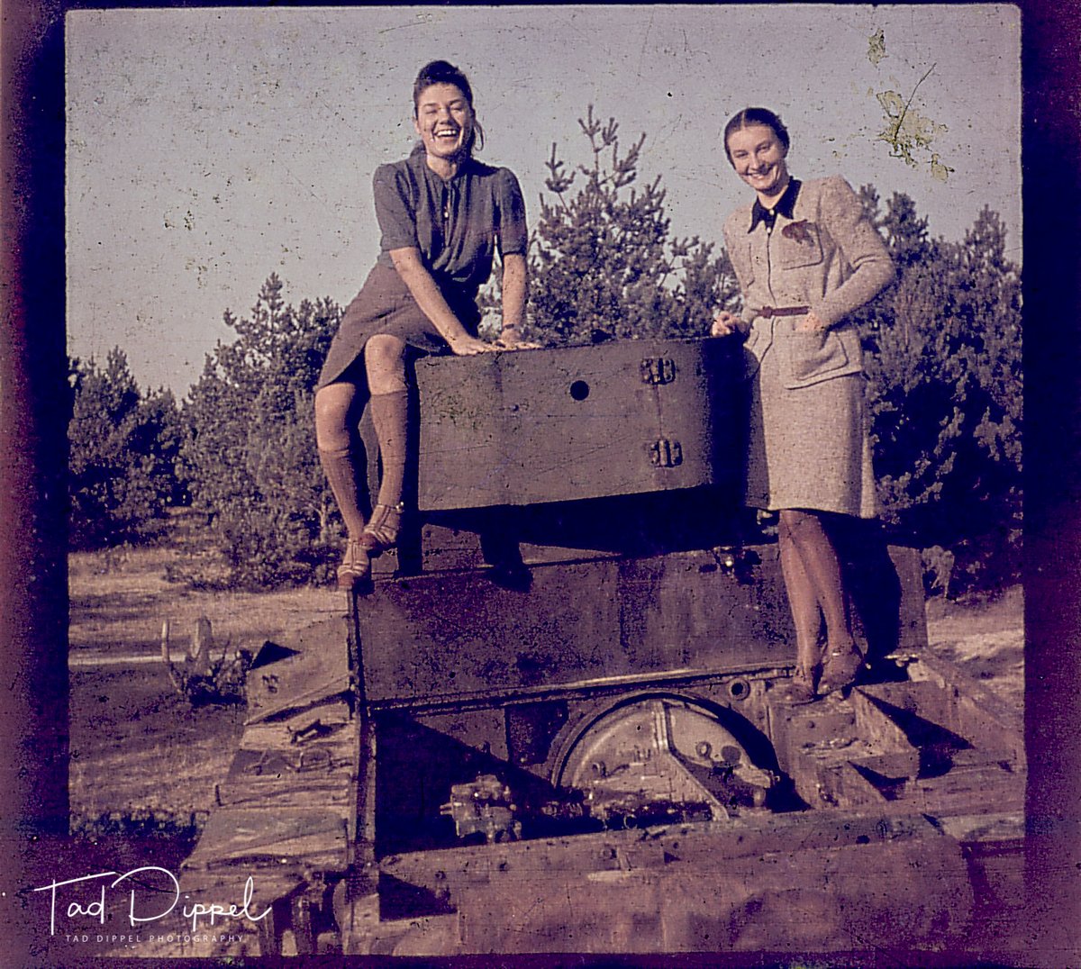 The recent photos from Ukraine of graduates posing in their wrecked building or on a tank reminded me of a photo that I have.  From an original colour photo, here is my aunt, Irena, with her close friend Hela posing on a wrecked tank in Brześć, now Brest in Belarus.