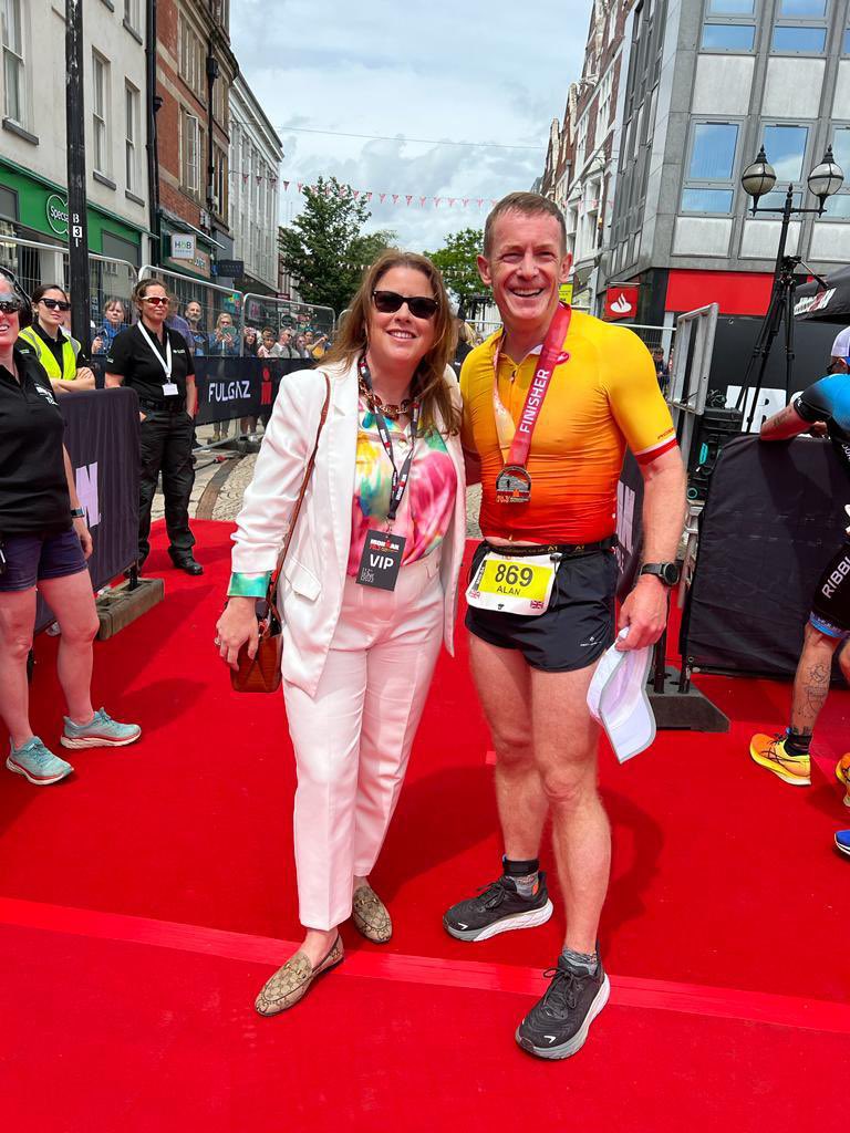 StaffordshireCC's tweet photo. Our very own Leader of Staffordshire County Council Alan White crossing the IRONMAN 70.3 Staffordshire finish line and getting his medal from colleague Cllr Victoria Wilson 
Superb show from him, and 2,999 other Athletes all in it together https://t.co/j8c4AoA11t