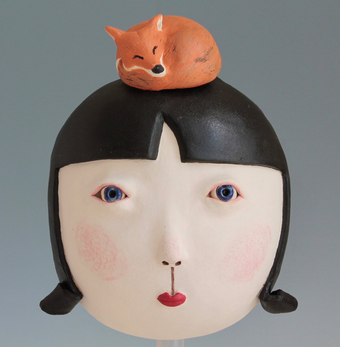 MidoriTakaki's tweet photo. Sleeping fox is dreaming. He is trotting in a meadow. The night is young and the moon is high. He glances up the tree where the Wise Owl often perches. The owl is not there tonight. There is a girl sting on the branch instead. 
#fox #ceramics #sculpture https://t.co/5Ry0zOMWKx