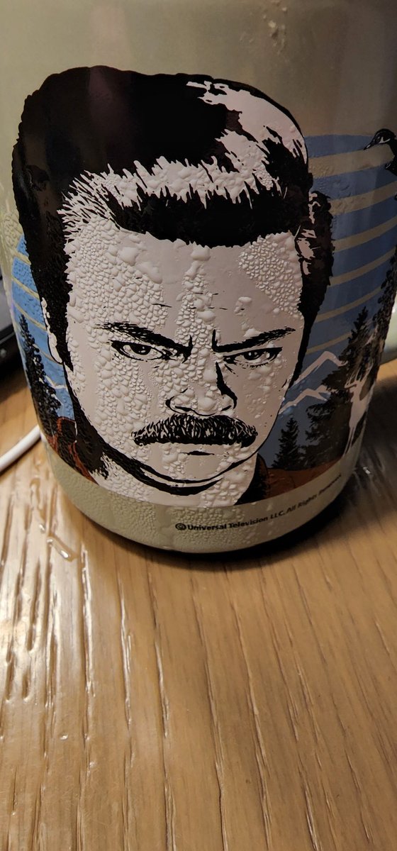 Not sure what I like more: My <a href="/Nick_Offerman/">Nick Offerman</a> Parks and Rec mug, or the fact that with some #lagavulin with a cube in it, he appears to sweat as if he were cutting down oak all day to use in the shop.