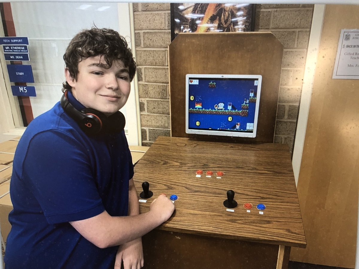 iLabYear5Days176-177: This photo captures so much! Logan along with our wonderful community volunteer Mr. Hunter from <a href="/NovoSolutions/">Novo Solutions</a> and our awesome gifted teacher @fok218 in collaboration with gifted and iLab students made a video game console and video game from scratch! 💙💚