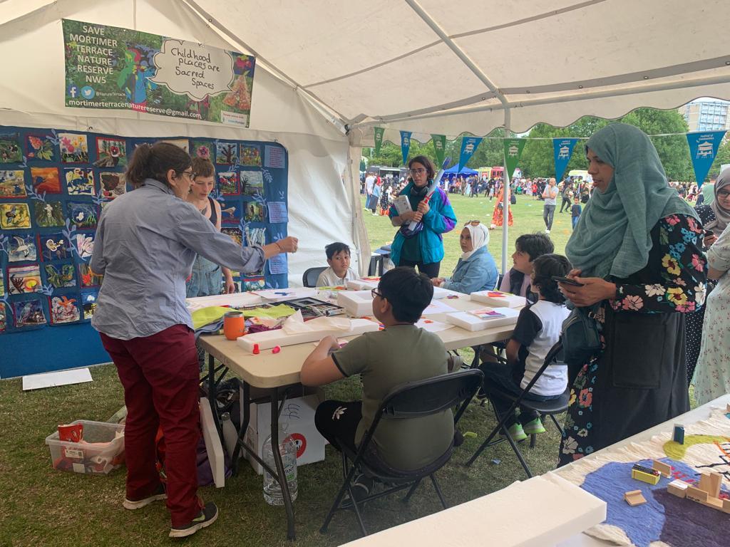 SAVE MTNR banner and Wildlife in Lockdown Quilt on display at the #festivalofcommunities 2022 #towerhamlets organised by <a href="/EngageQM/">Queen Mary Centre for Public Engagement</a> this Saturday #NatureNotProfits #Springwatch #saveMTNR