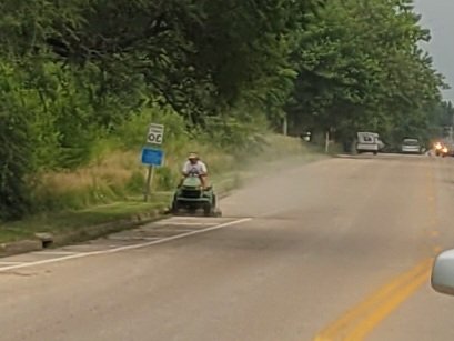 DaxFoy's tweet photo. This nimrod is mowing the street over on Harrison, blowing dust and rocks all over the cars as they pass. #theywalkamongus #cantfixit https://t.co/qLSKqPOO1f