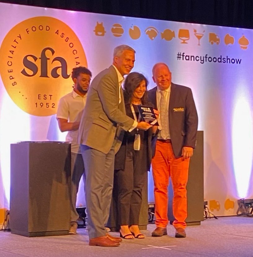 MaracaiboMedia's tweet photo. It was a great honor to accept the Hall of Fame Award for Marygrace Sexton at The @Specialty_Food Association 2022 Summer Fancy Food Show 🍊🏆
#FancyFoodShow #sofiAwards #SFABasics #sfa #drinknatalies @Nataliesoj https://t.co/B6tqi7xzlG