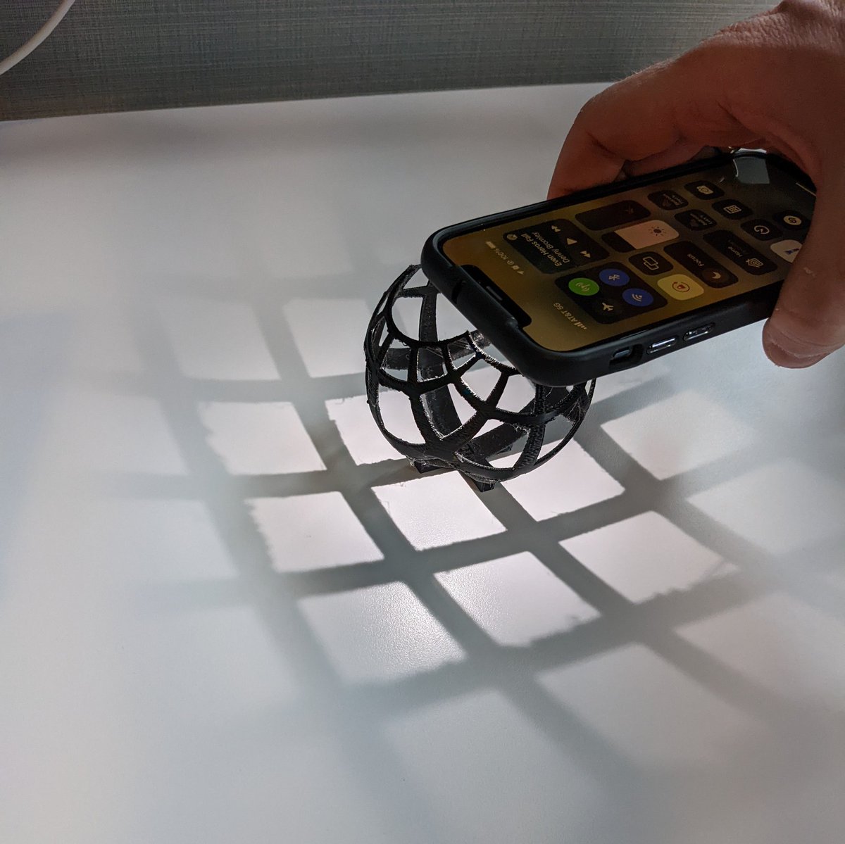 mapsOverlord's tweet photo. What joyous thing is this? 3d printed globey shape that casts a regular grid shadow when the light is in the right direction. One of my teammates printed this for me. I have the best colleagues to work with @tableau! Made the morning in office more fun #mapProjectionsAreHard https://t.co/cXk7RffaQD