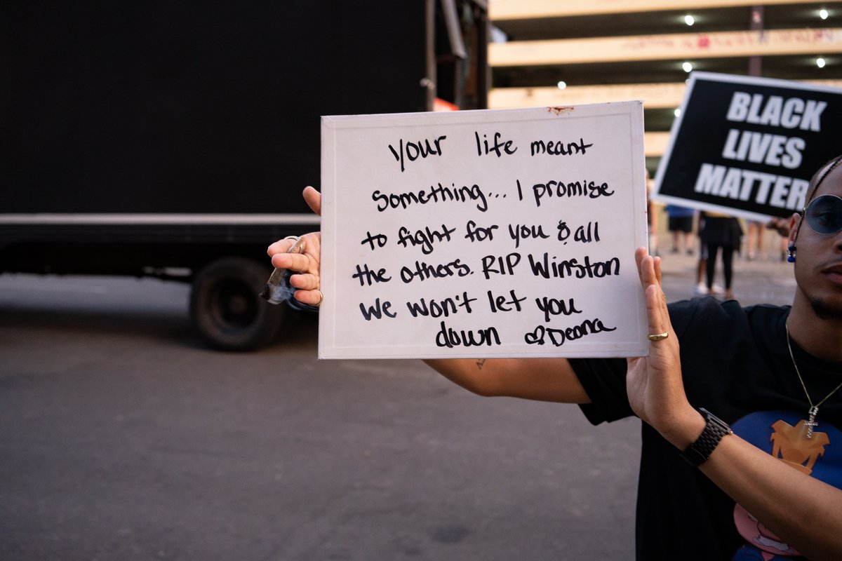 daviss's tweet photo. A year ago Deona Marie Knajdek was killed when a driver drove through barricades placed by those protesting the killing of Winston Smith 10 days prior. Photos of her memorial & what i'm told was her protest sign. Days later hundreds gathered on what would have been her birthday. https://t.co/dY9sxFCBEY