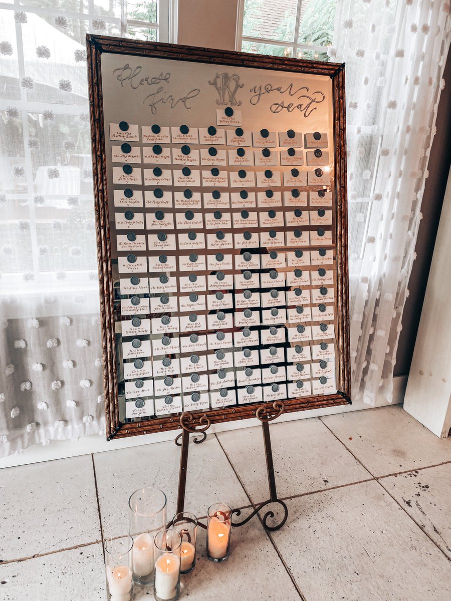 kristendip's tweet image. My largest installation to date: a mirror seating chart with escort cards and wax seals bearing the couple’s monogram. Every detail done by hand, from pressing all 121 wax seals, calligraphing each card, and calculating the math to make it all fit. #calligraphy #seatingchart