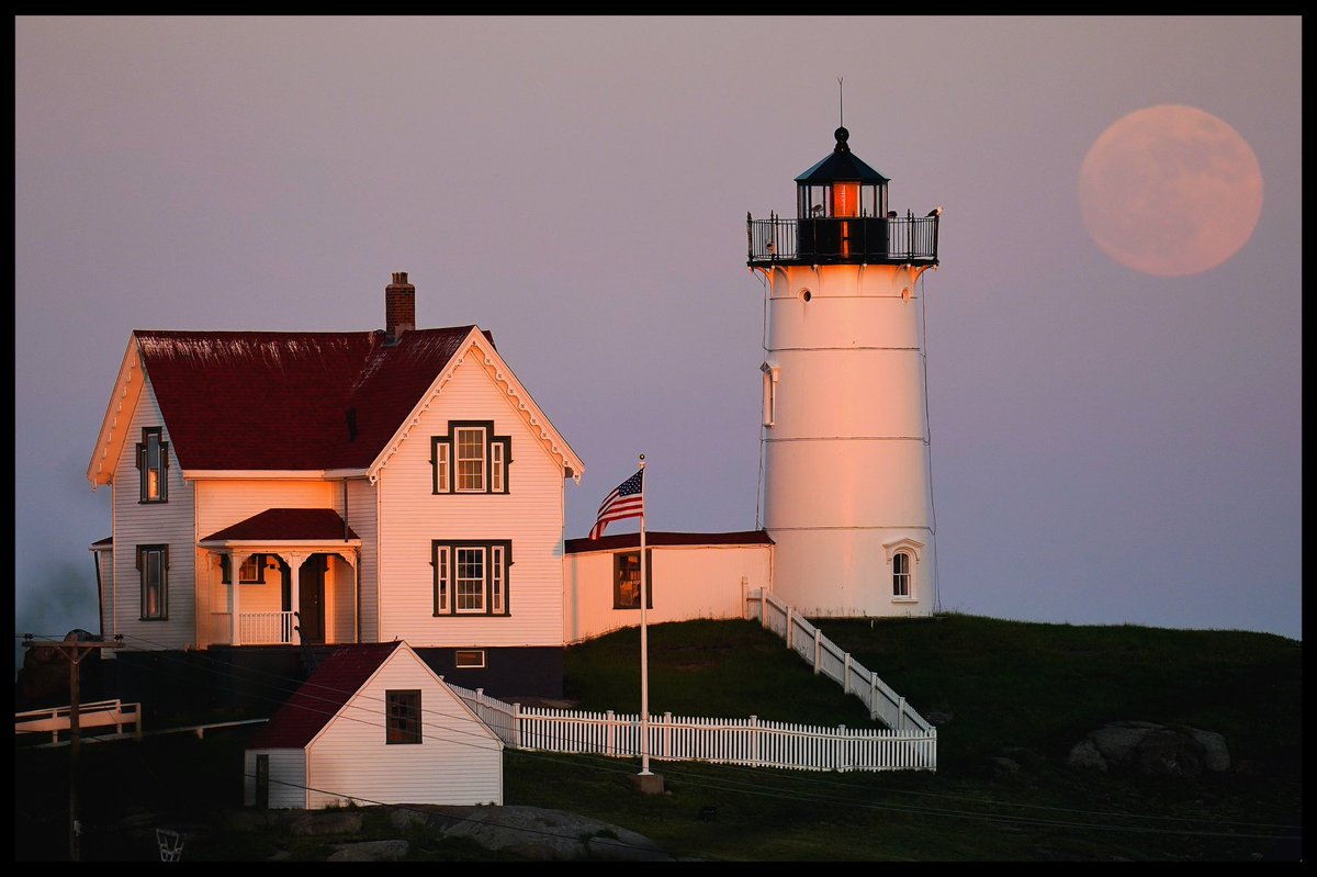 JulioCortez_AP's tweet photo. A waxing gibbous moon is seen at 98%  full near the Nubble Light, Monday, June 13, 2022, in York, Maine. The moon will reach its full stage on Tuesday, during a phenomenon known as a Supermoon because its proximity to Earth, and it is also labeled as the “Strawberry Moon.” https://t.co/9XS7ENMwGl