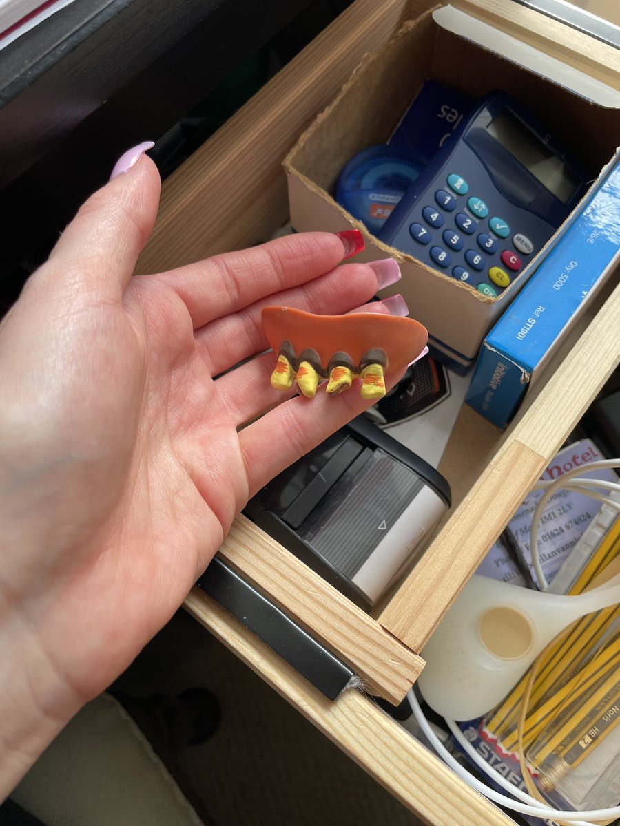 Working at my dad’s desk while I’m home, looking for a pen in the draws but instead I find: testicle bike lights and a set of joke false teeth #businessessentials