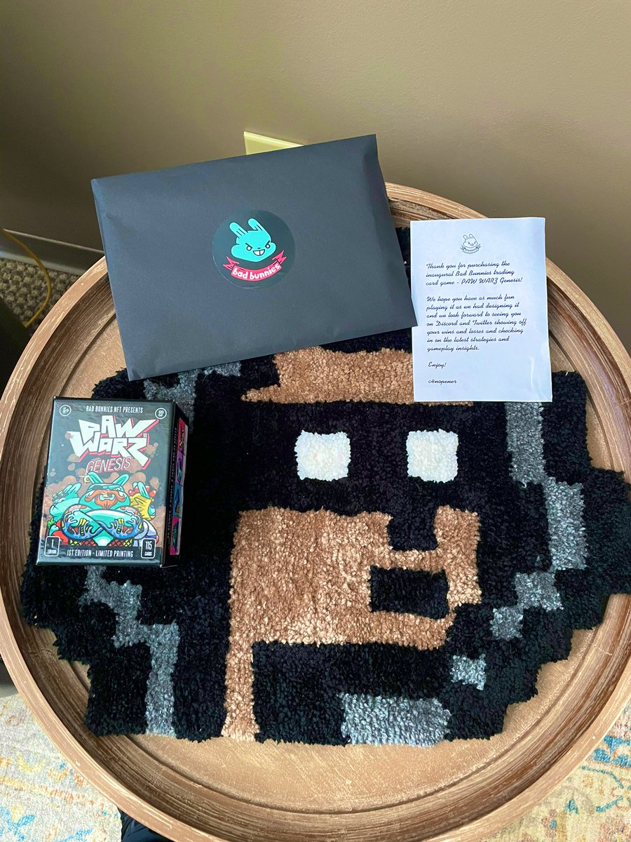 kidlightning84's tweet photo. My NFT table just added some more items. 1st edition @BadBunniesNFT card game to go along with my custom @nftrugbabe! @cryptobabypunks https://t.co/mAPm0LuNmL