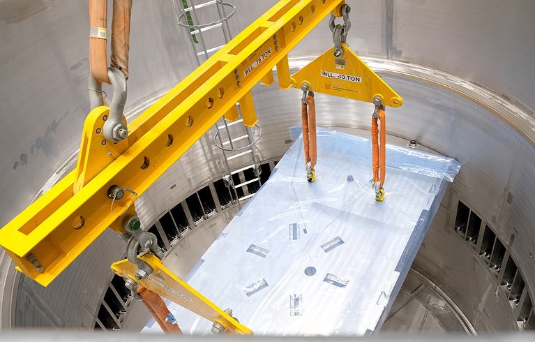 essneutron's tweet photo. The first inner shielding block landed in the #ESS Monolith today! Some 1,000 tonnes of steel shielding will be stacked inside the vacuum vessel, around the Target wheel and moderator system. The 1st piece lowered inside is a support plate for the reflector base.
#buildingESS https://t.co/IAjR2mrqqo