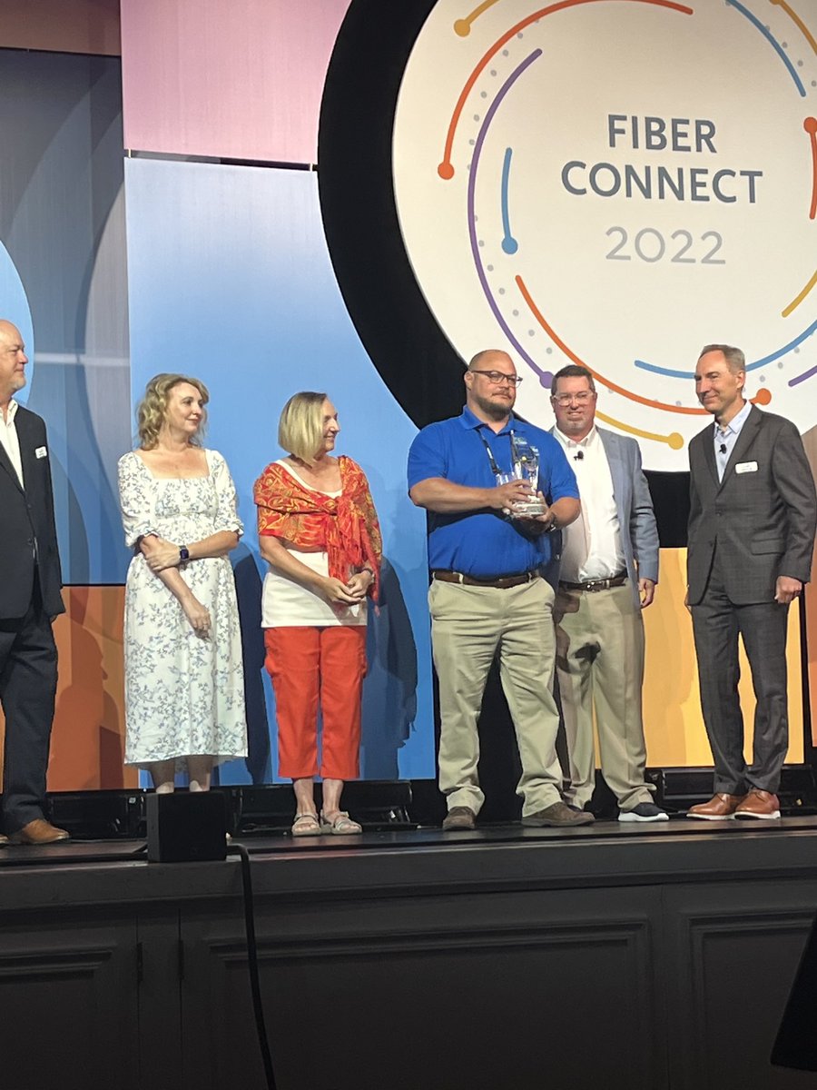 NCPubBBND's tweet photo. .⁦@fiberbroadband⁩ gave the Gene Scott Education award today. ⁦@WilsonNC⁩ ⁦@greenlightnc⁩ received it for piloting the first fiber splicer training course with Wilson Community College-this was Gene’s dream. Jimmy Hendricks, Gene’s wife &amp; daughter accepted. https://t.co/miK87EXWBX